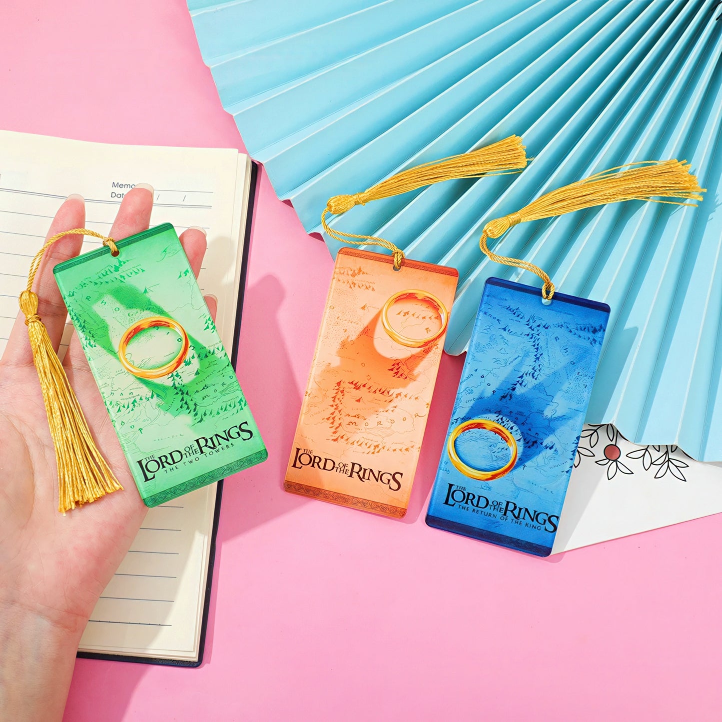 'The Lord of the Rings' themed acrylic bookmarks on a pink and blue background
