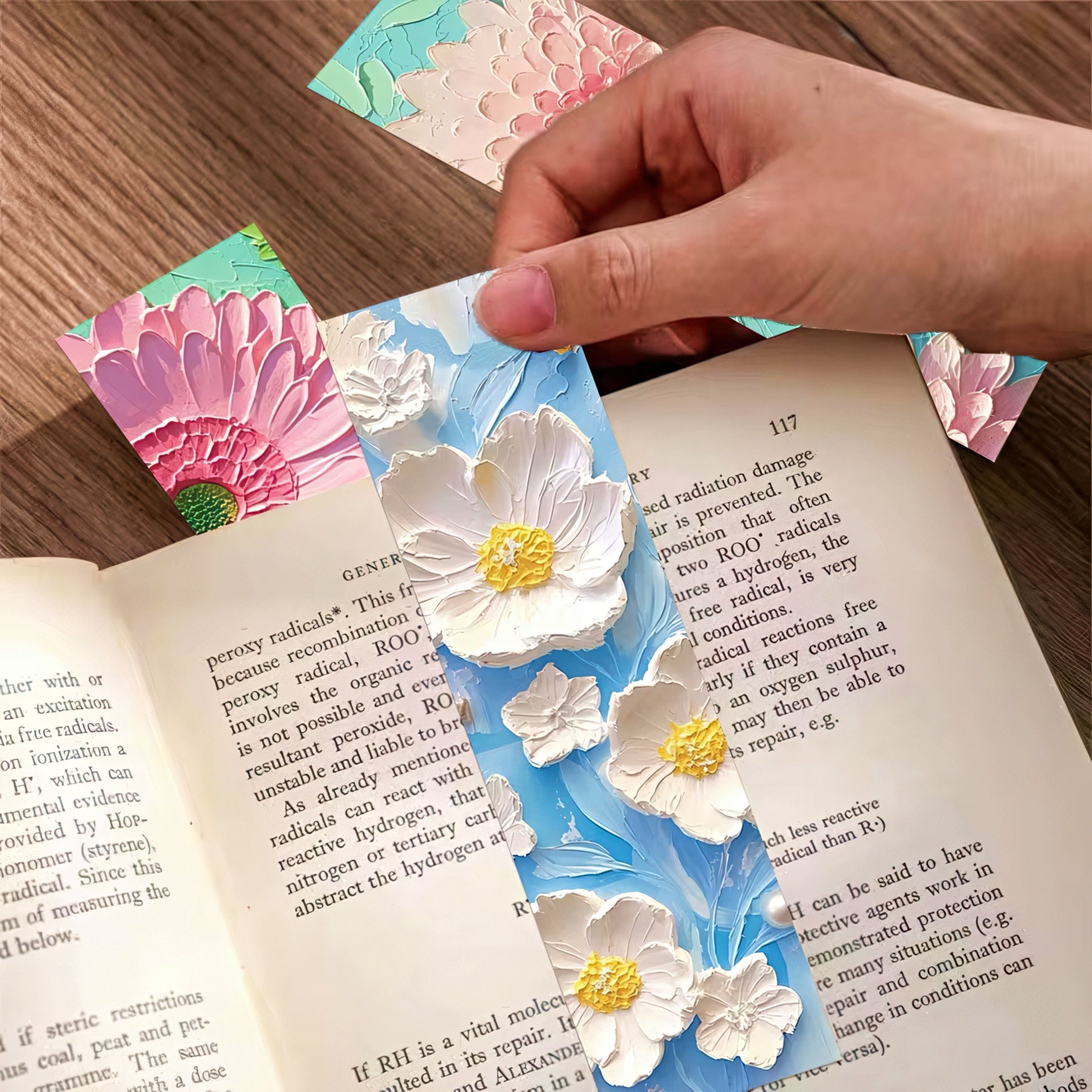Floral paper bookmark with white flowers on a book page